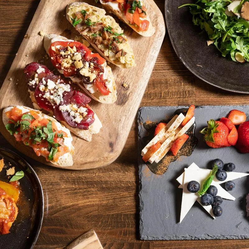 Various prepared dishes served on various boards and plates