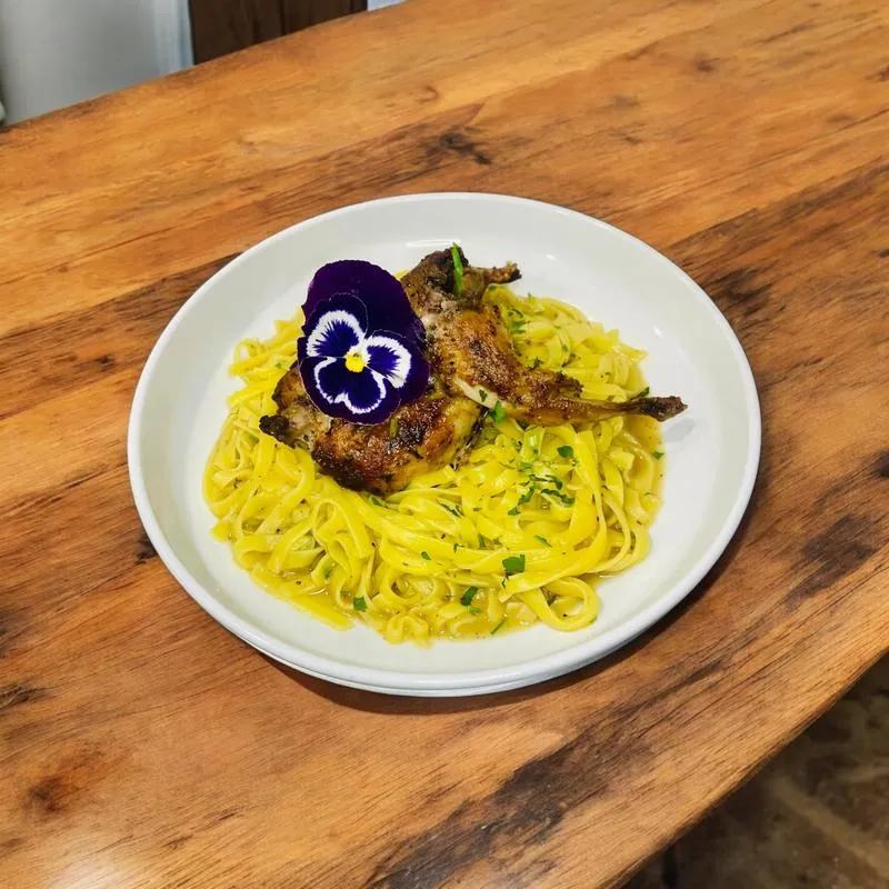 Pan seared quail over Albanian pasta.