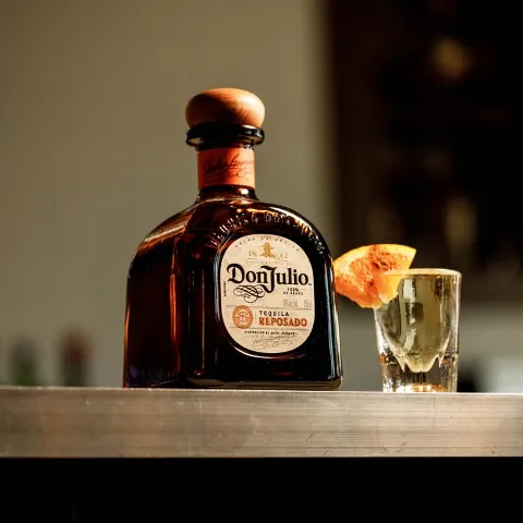 Bottle of tequila and a shot glass.