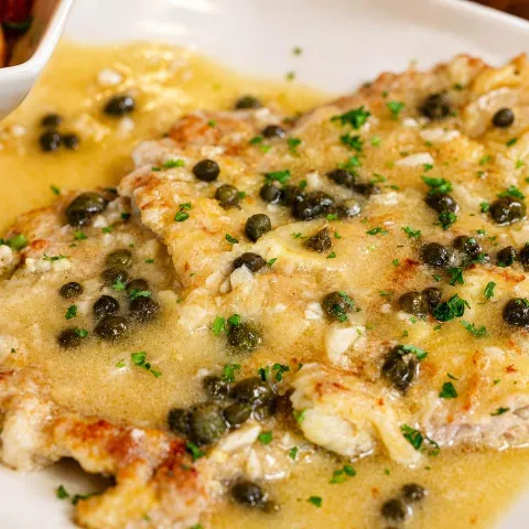 Battered veal cutlet, with white wine, lemon, butter, and caper sauce.