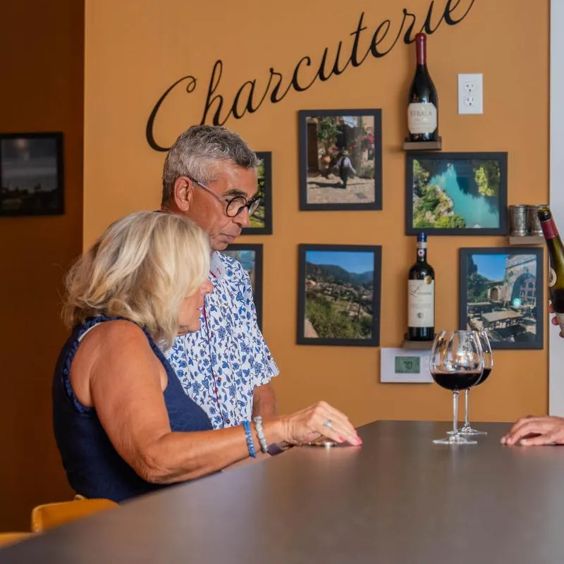 Interior, a couple enjoying wine at a counter.
