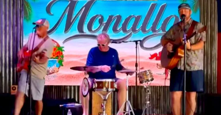 A Group Of People Playing Instruments On A Stage