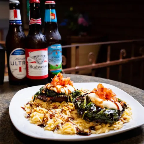 Portabella Mushrooms served over risotto with  sauteed spinach.