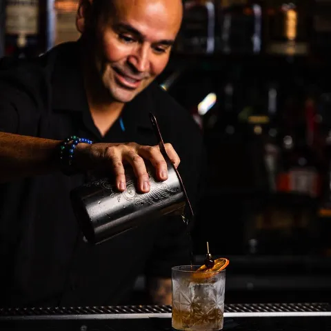 Bartender preparing drink.