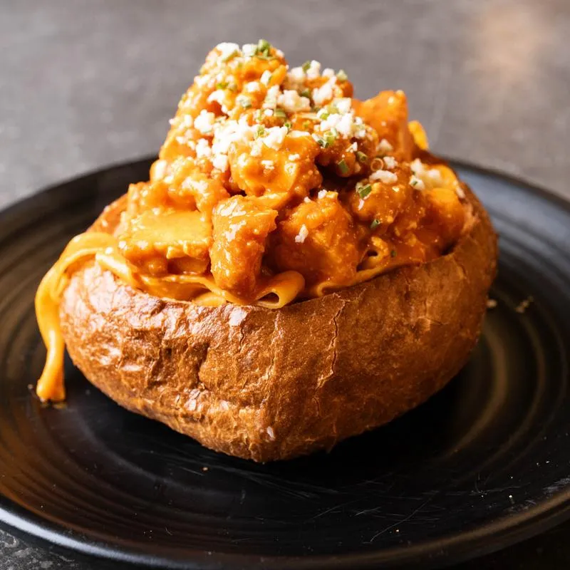 Buffalo Chicken Pasta Bomb served in a bread bowl.