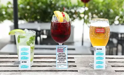 three glasses - wine, beer, and cocktail - with Lock N Key Happy Hour drink pull tabs