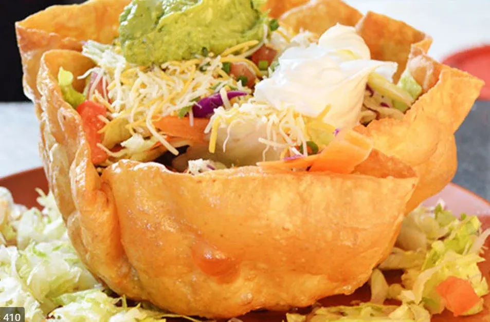 Wicked Fajita Salad Bowl (Chicken)-Taco shell nestled with lettuce, pico de gallo, cheese, sour cream, guacamole, corn salsa and, house dressing. Served with well seasoned tender strips of Chicken wit
