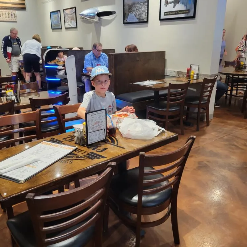 Child eating at a table in a casual restaurant.
