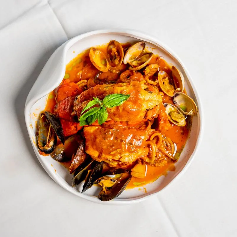 Seafood soup with clams, mussels, lobster tail, and fish.