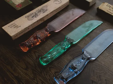 Vintage Depression-era pressed glass cake knives in pink, green and cobalt