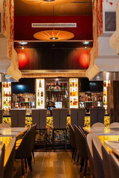 Illuminated contemporary bar and seating area at Coral Springs