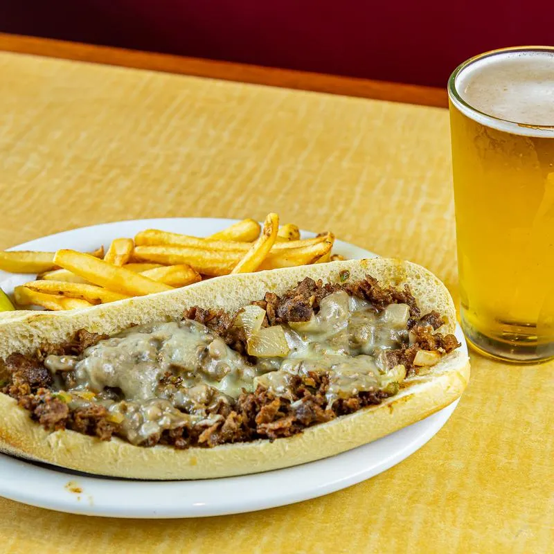 Philly Cheesesteak, fries, and beer.