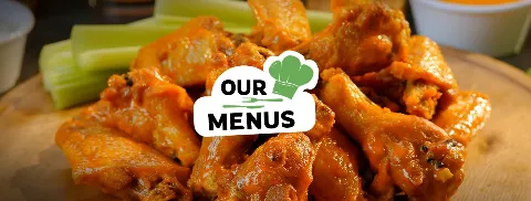 a mound of sauce covered wings sits in front of a pile of celery sticks and several dipping cups