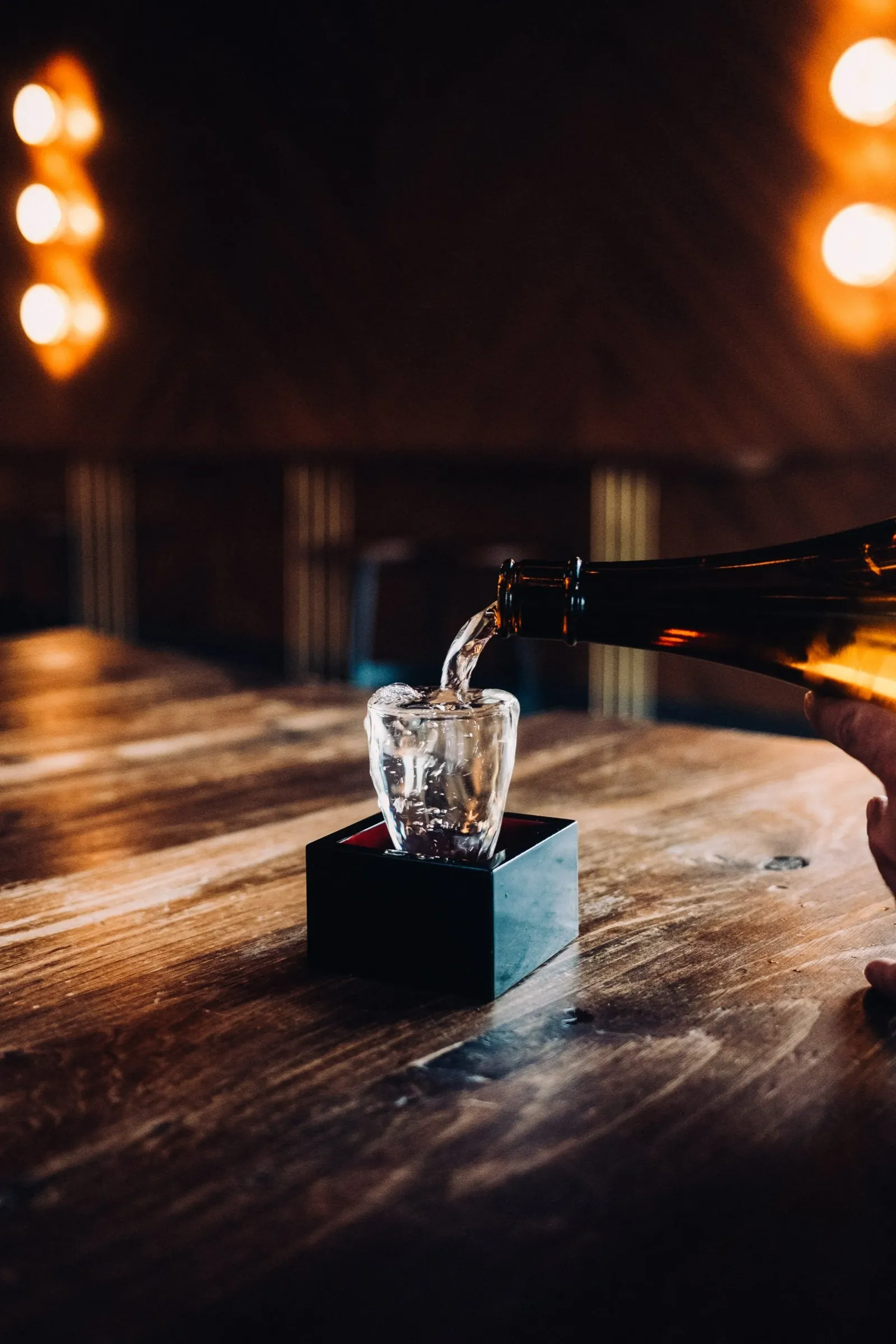 sake being poured into a sake cup