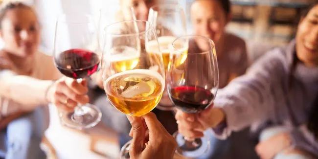 A Group Of People Holding Wine Glasses