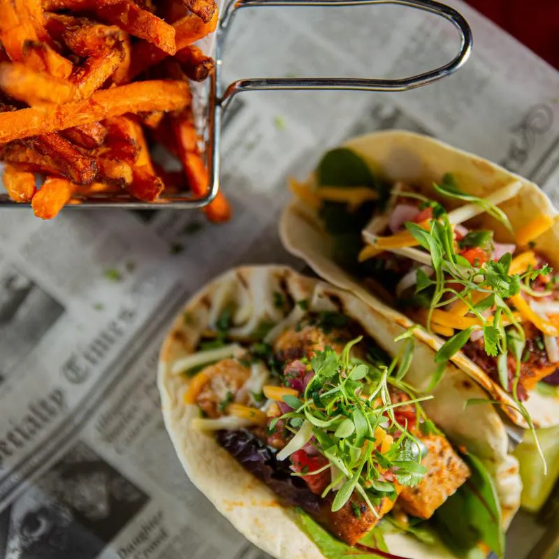 Fish tacos with basket of fries on the side.
