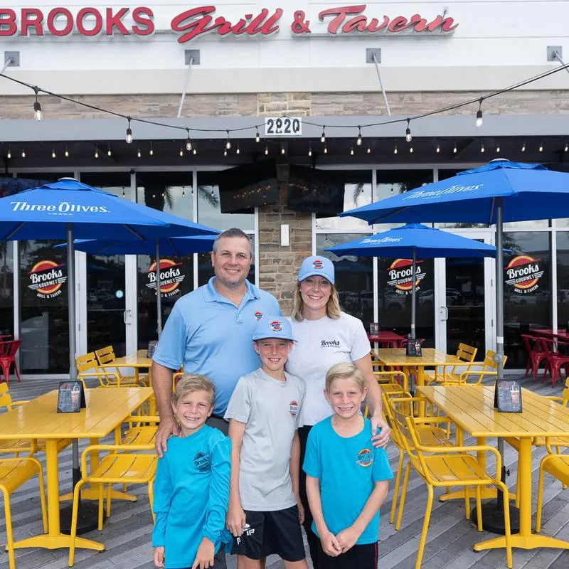 Family of five posing outside the restaurant.