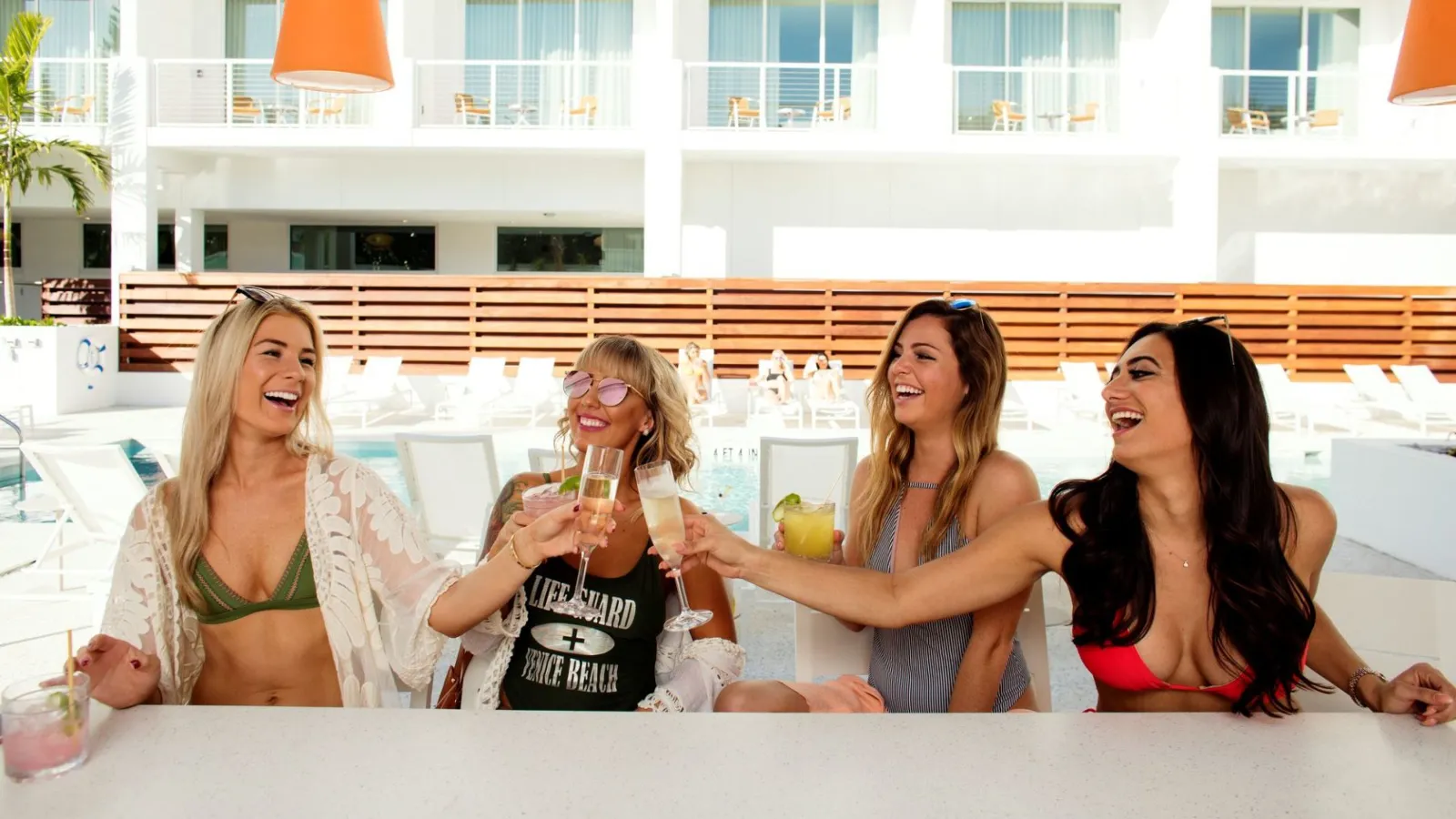 A Group Of Women Sitting At A Table With Drinks