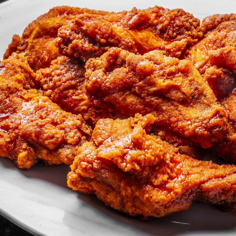 Buffalo wings coated in spicy sauce.