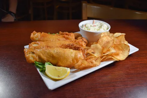 Reel in the flavor! Our Fish 'n' Chips features crispy battered cod, golden and delicious, served with a side of tartar sauce and crispy fries