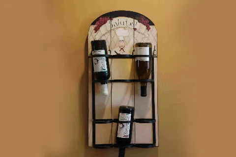 Wall-mounted wine rack with chef artwork