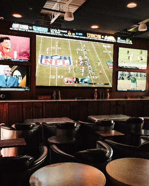 Sports bar at Primrose Lanes with multiple TVs showing live sports