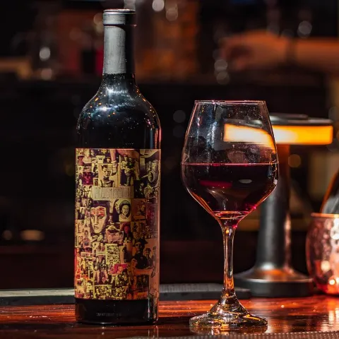 A bottle and glass of Abstract Red Blend.