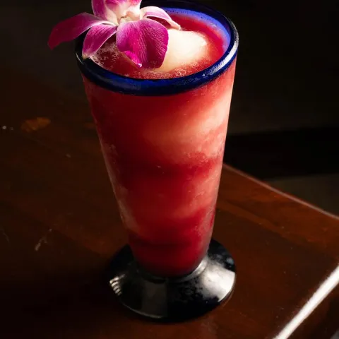 Frozen Sangria garnished with a purple orchid.