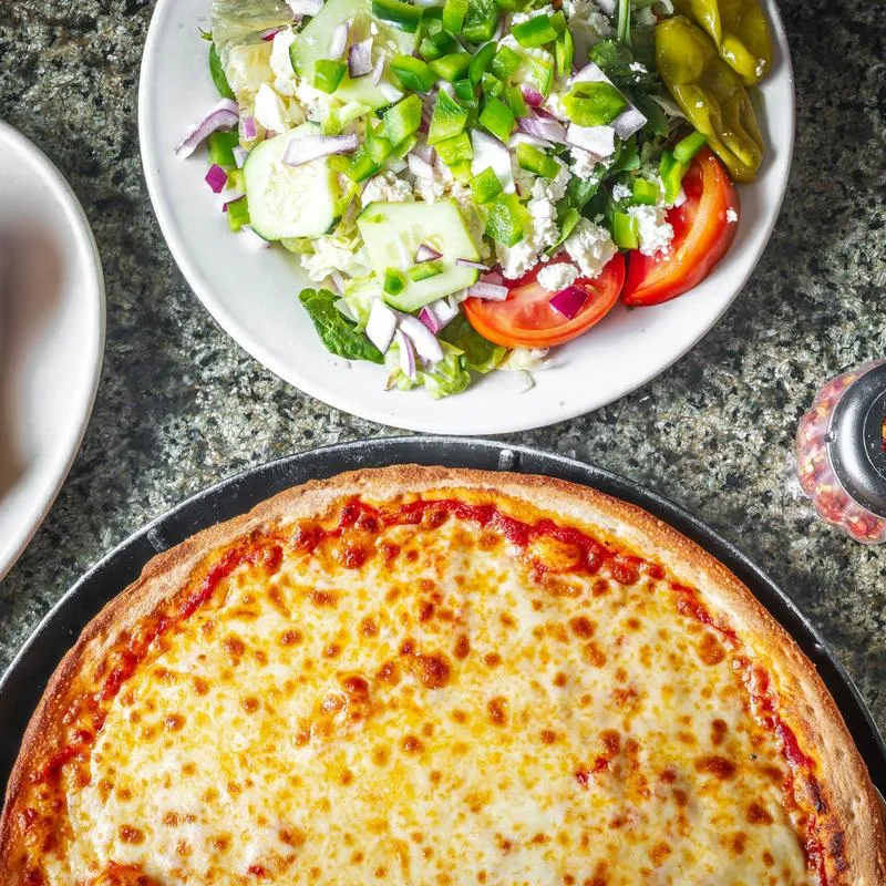 White pizza paired with a fresh Greek salad.