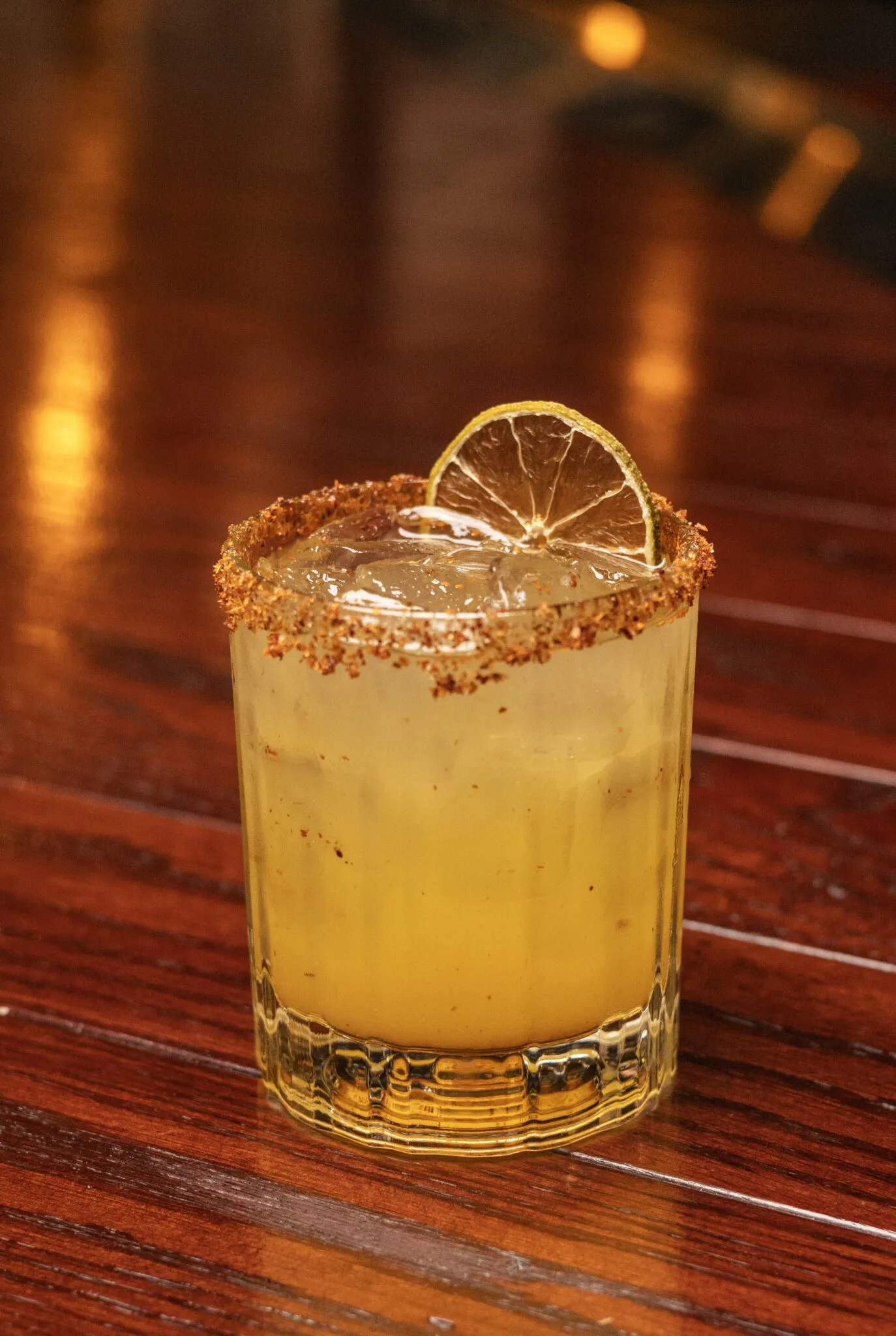 Cocktail with chili-salt rim and lime