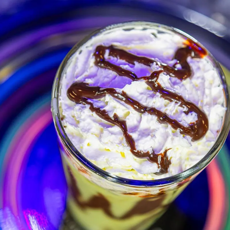 Saturns Ring  drink with whipped ctream and chocolate sauce.