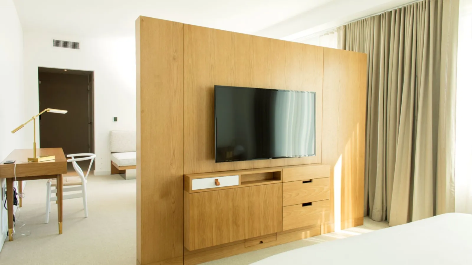 A Room With A Tv And A Bed
