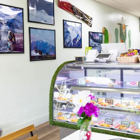 Interior, seating, wall decor and bakery display case.