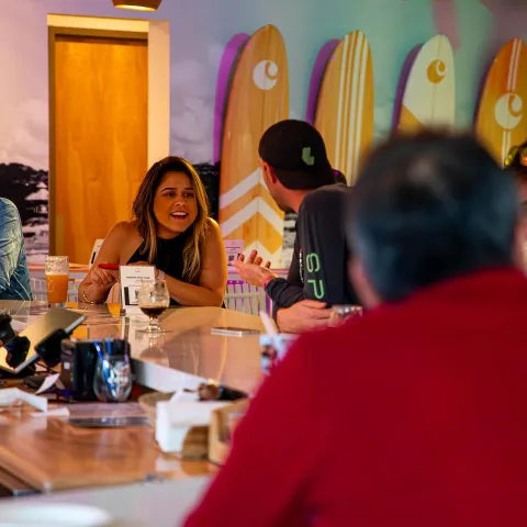 Customers sitting at bar counter enjoying their time and drinks.