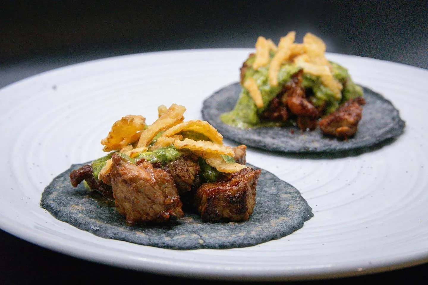 Steak tacos 🤤 The first of many staples by @chefdillon. 
-
On our fresh heirloom indigo corn tortillas, Oaxacan marinated steak with chimi-churri and fried onions. 🌮 
-
-
#conarmorfl #conamor #tacos