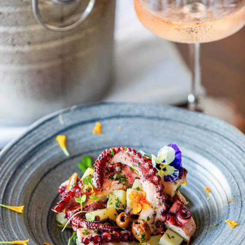 Octopus salad accompanied with champagne.