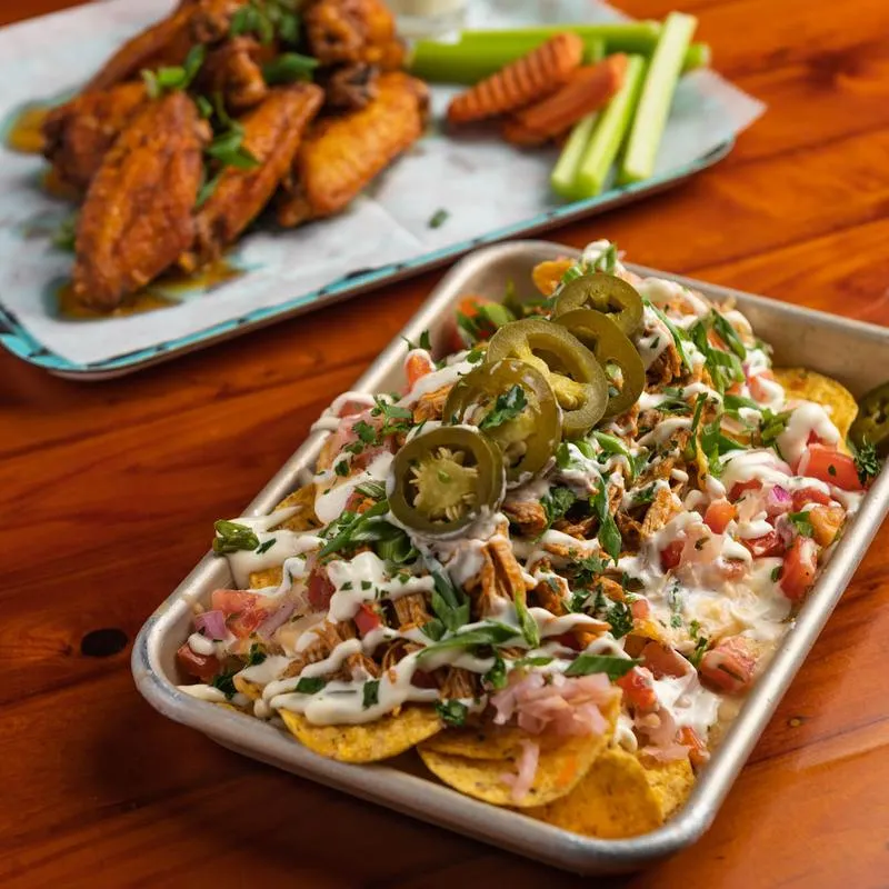 Chicken nachos platter and tang wings platter