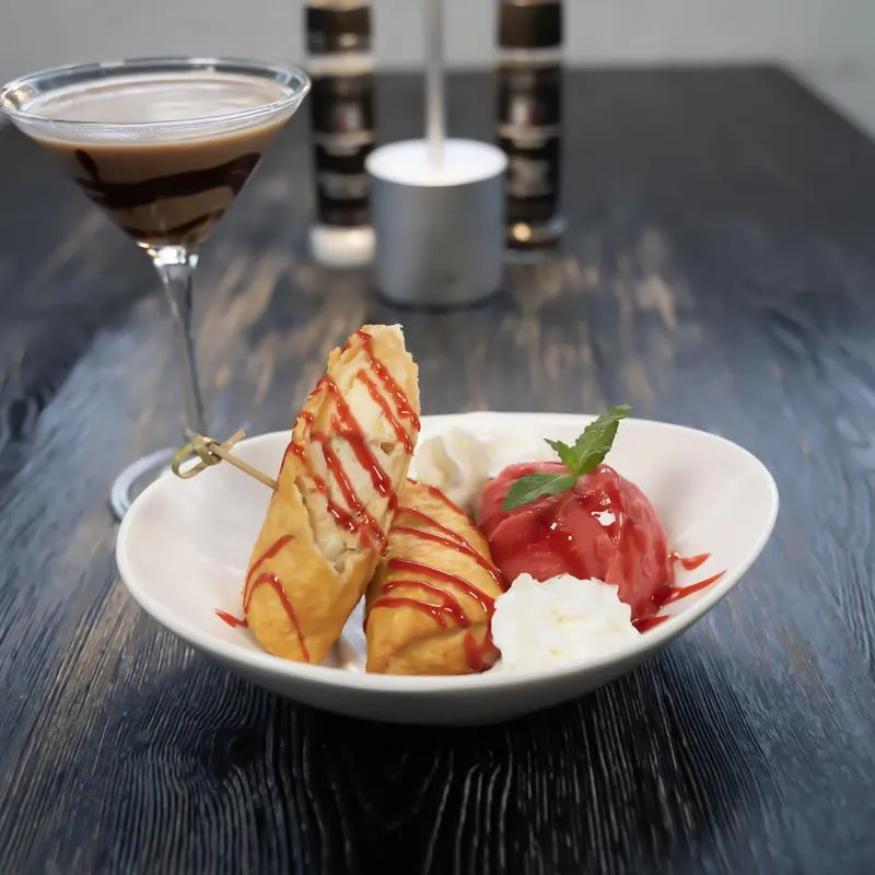 Cheesecake served with Raspberry-Sorbet, paired with a chocolate martini.
