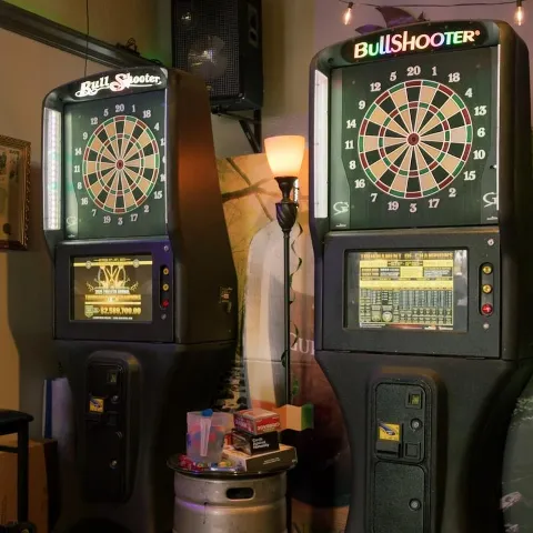 Electronic dart machines, inside of the pub.