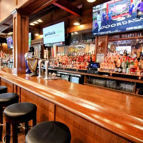 Interior, bar, chairs, screens above.