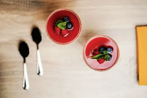 A couple of cups filled with fruit on top of a table.