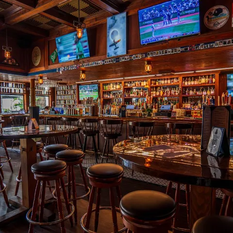 Restaurant interior, high seating area, bar in the back.