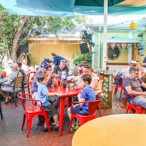 Exterior, restaurant seating area, people sitting at their tables