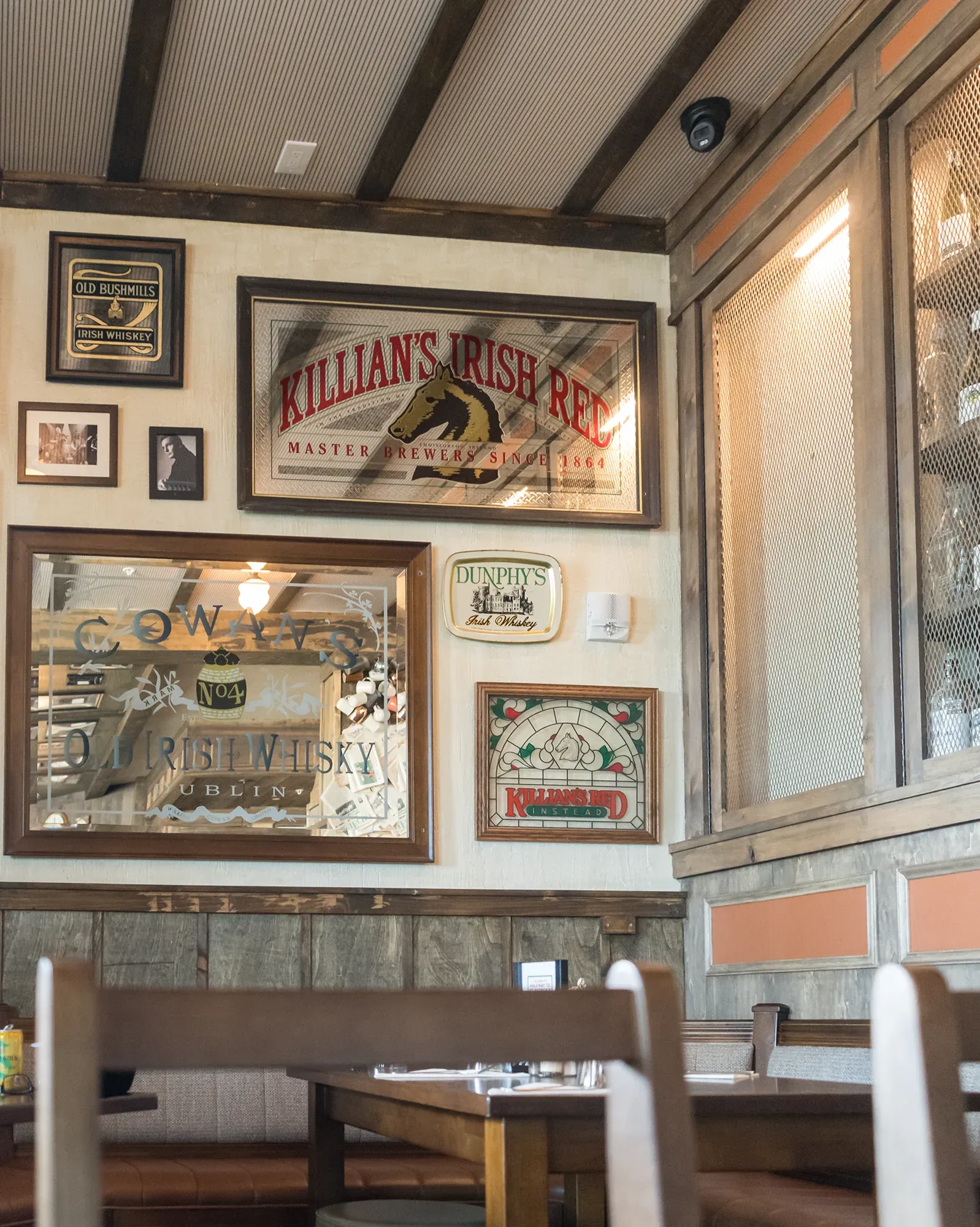 Vintage beer and whiskey mirrors above booth seating at Delany's Public House.