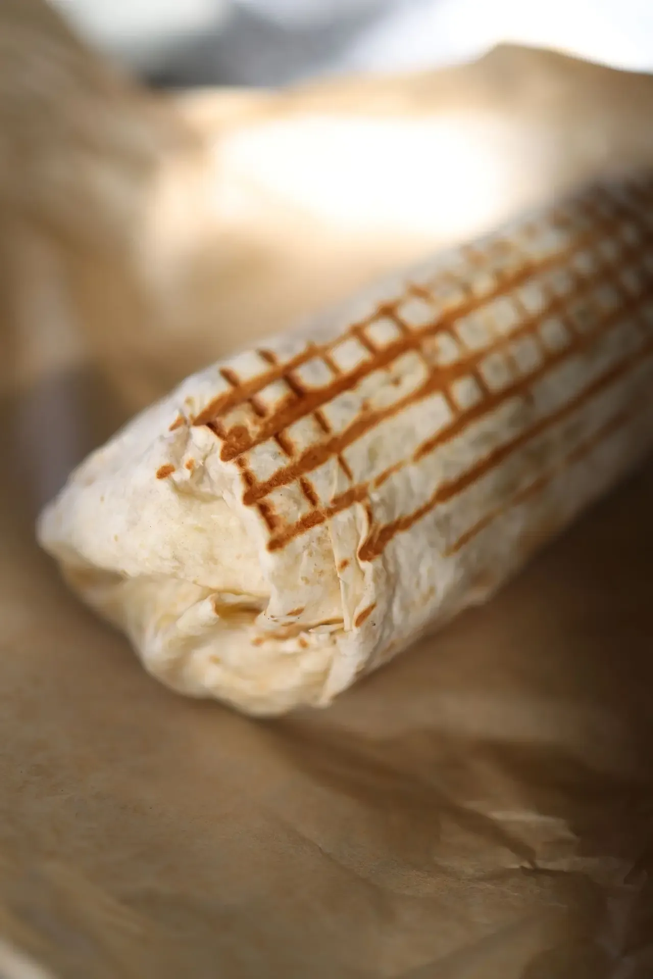 Griddled burrito filled with meat, rice and beans