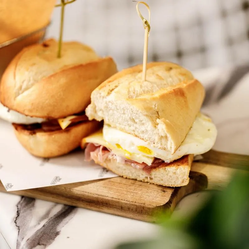 Breakfast Prosciutto Panini sliced in half and served.