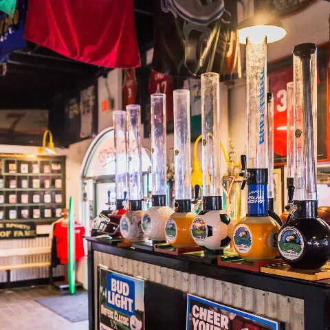 Draft beer taps and beer towers lining the bar at Bogey's Sports Pub in Venice, FL with sports memorabilia and HD TVs in the background
