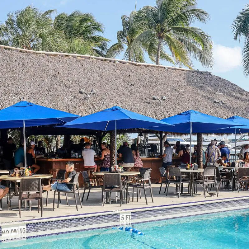 Outdoor patio seating area with parasols by the pool.