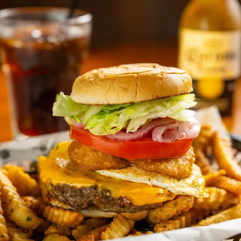 Fat Boy Burger with curly fries, close-up.