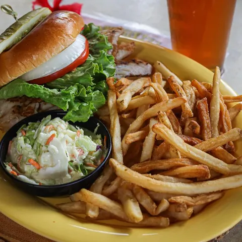 Grouper sandwich, with tomato, lettuce, onion, pickle, coleslaw and fries